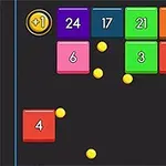 色とりどりの数字が付いたブロックと黄色のボールが黒い背景に表示されている。