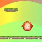 虹色の背景に緑の草が生えたプラットフォームの上で赤いキャラクターが跳んでいる。