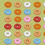 さまざまな色とフロスティングを施したドーナツが5行6列に整然と並んでいる。