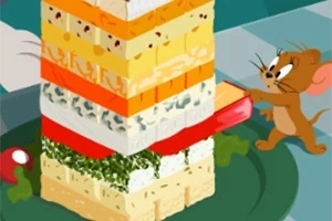 ネズミがチーズとハーブの層を積み重ねたタワーを食べようとしている。