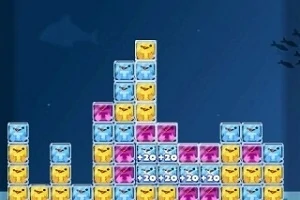 青、黄、紫のブロックが積み上げられた画面で、各ブロックには顔が描かれている。