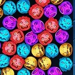 カラフルな怪物の顔が詰まったボールが黒い背景上に並んでいる。